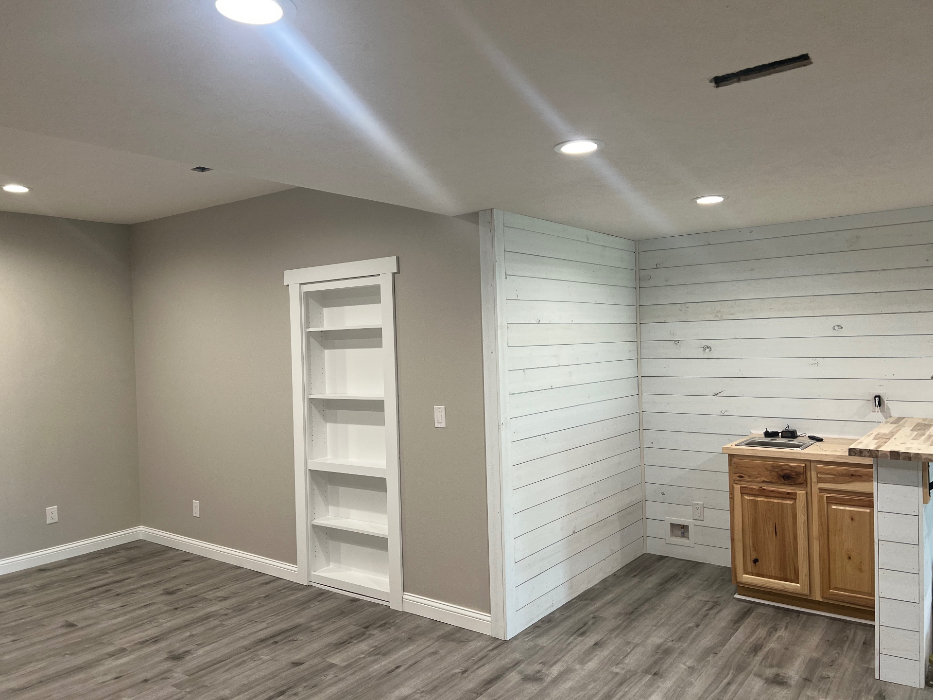 Finished basement with whitewashed shiplap accent wall — Republic, MO