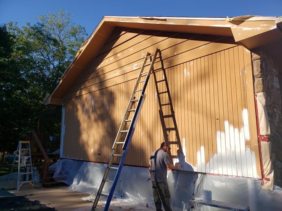 Exterior painter in Battlefield, MO prepping a board-and-batten gable